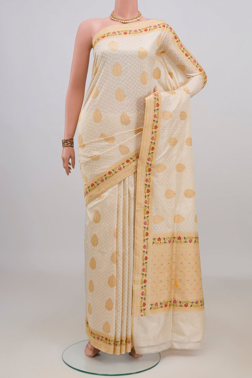 Pure Silk Cream Banarasi Saree with Jacquard With Zari Butta on the body and Zari Border.  displayed on a mannequin
