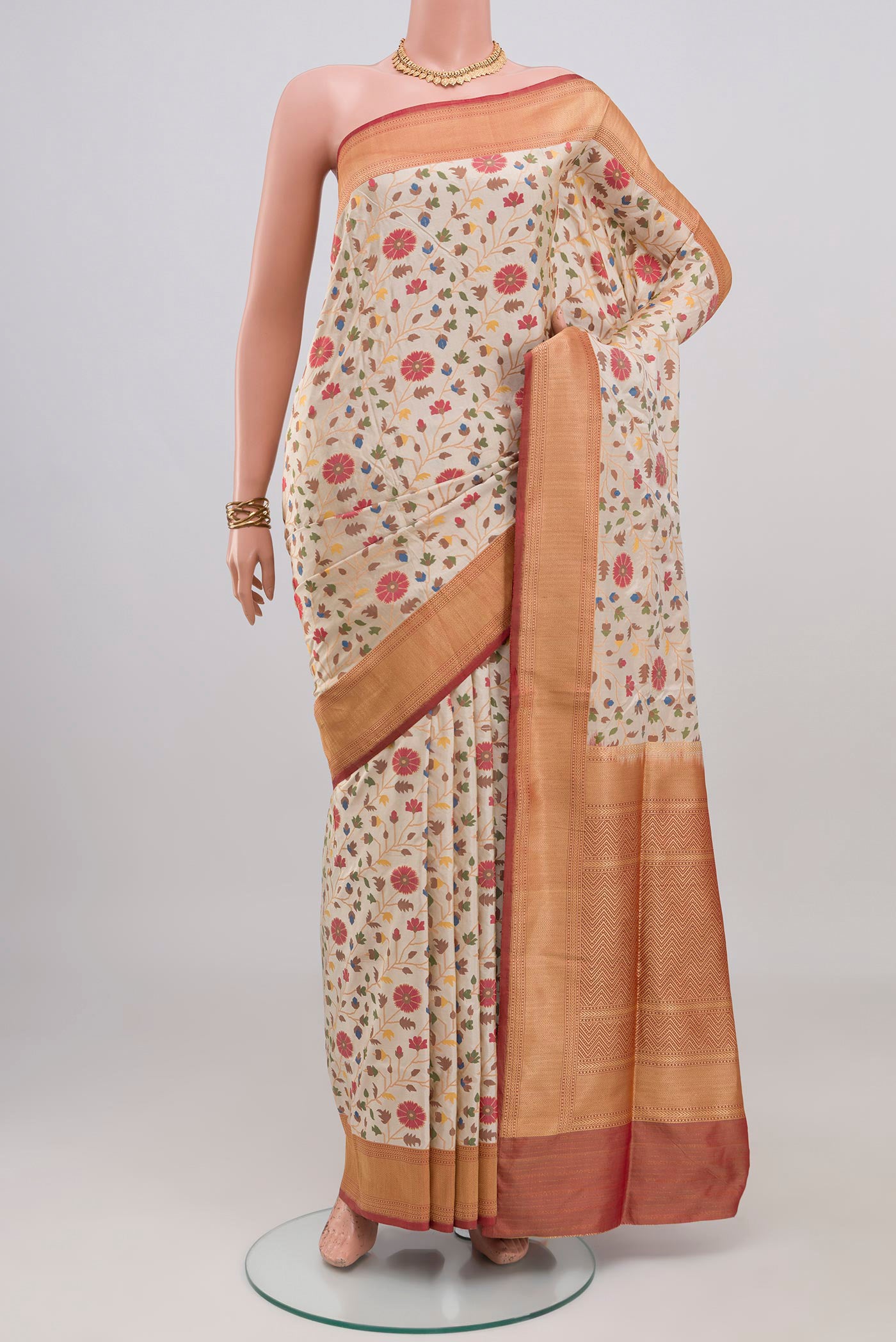 Cream Banarasi Silk Saree with Zari And Thread Butta on the body and Zari Border.  displayed on a mannequin