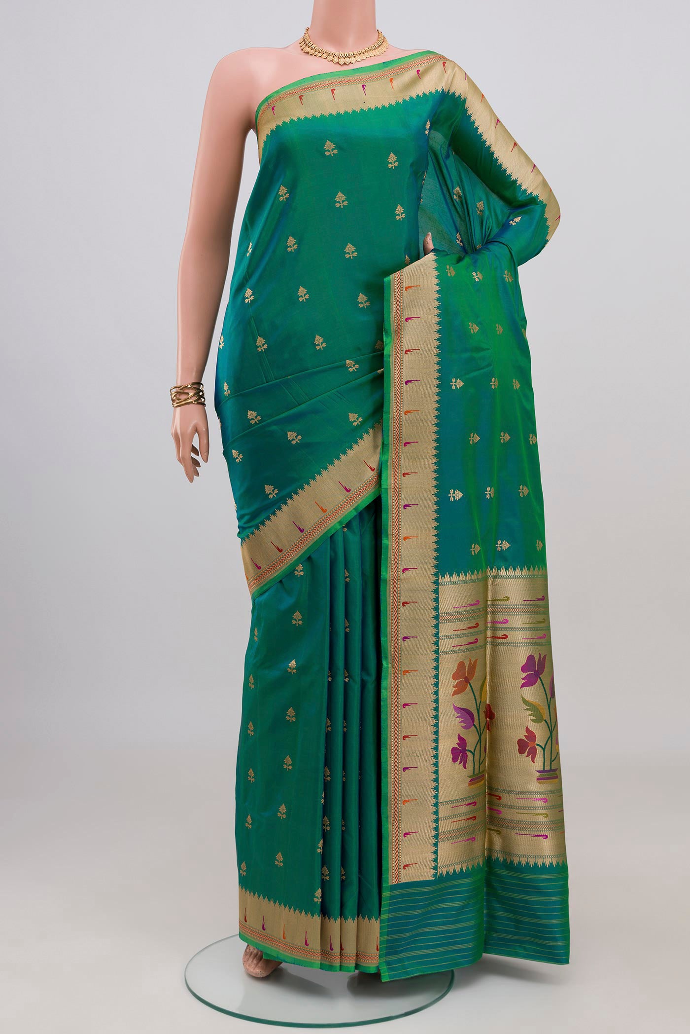 Peacock Blue Banarasi Silk Saree with Zari Butta on the body and Zari Border.  displayed on a mannequin