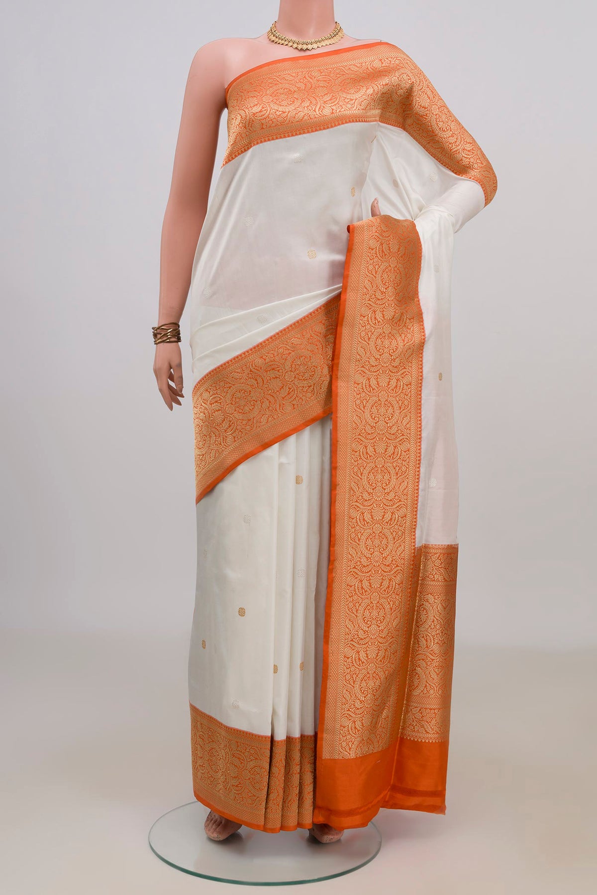 Pure Silk White Banarasi Saree with Zari Butta on the body and Fancy Border.  displayed on a mannequin