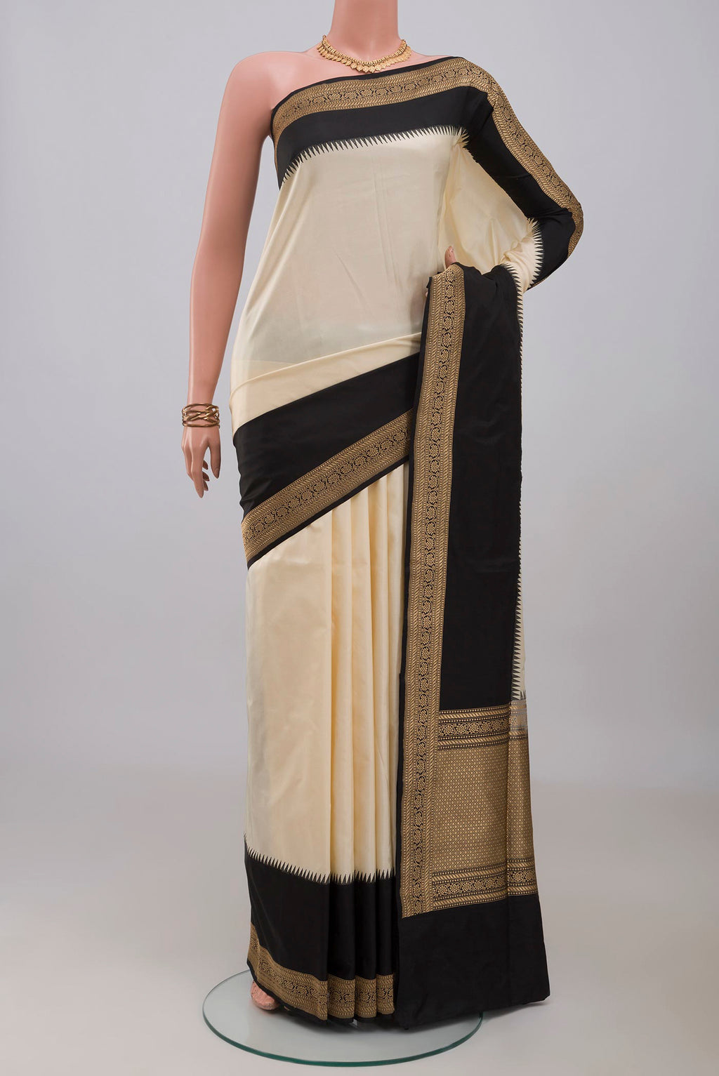 Cream Banarasi Silk Saree with Plain Body and Zari Border.  displayed on a mannequin