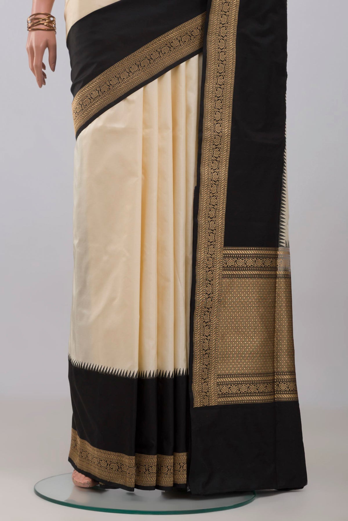 Pleats and pallu of Cream Banarasi Silk Saree with Plain Body and Zari Border. 