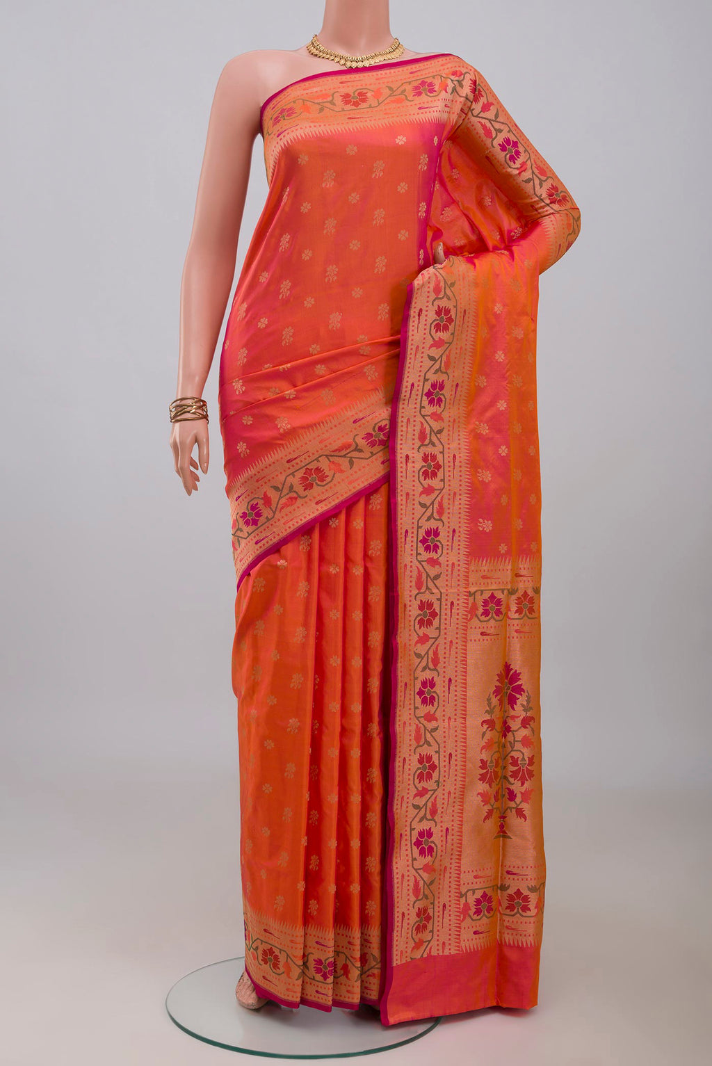 Pinkish Yellow Dual Tone Banarasi Silk Saree with Zari Butta on the body and Zari Border.  displayed on a mannequin