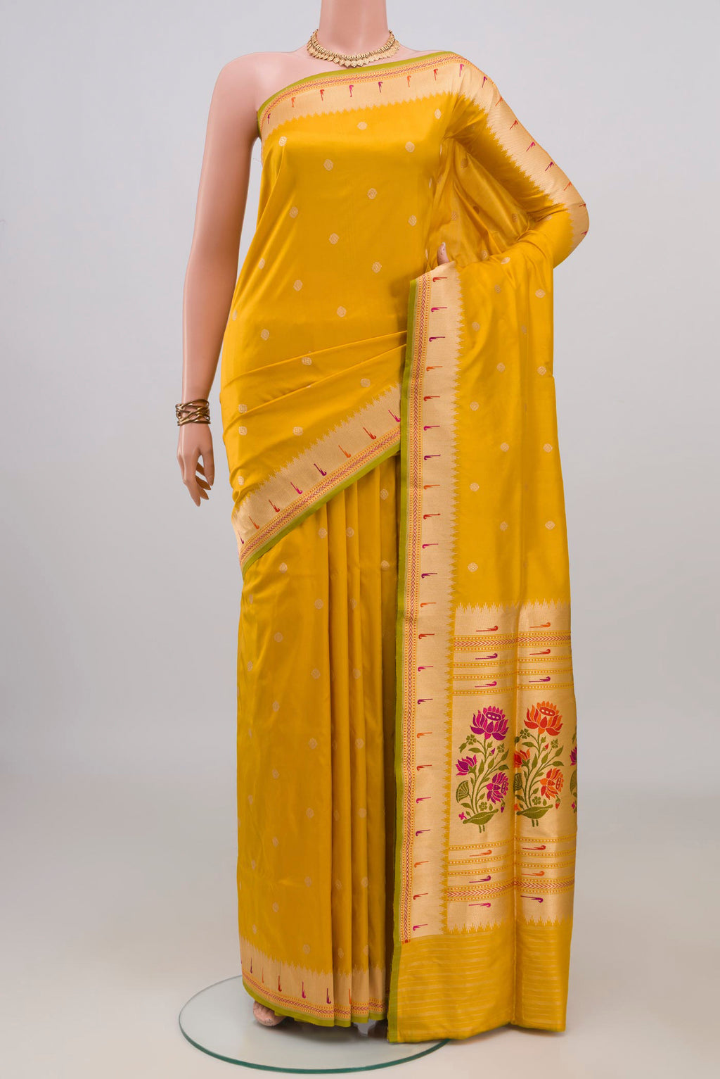 Pure Silk Yellow Banarasi Saree with Zari Butta on the body and Fancy Border.  displayed on a mannequin