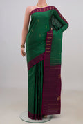 Pure Silk Green Kanchipuram Saree with Zari Butta on the body and Fancy Border.  displayed on a mannequin