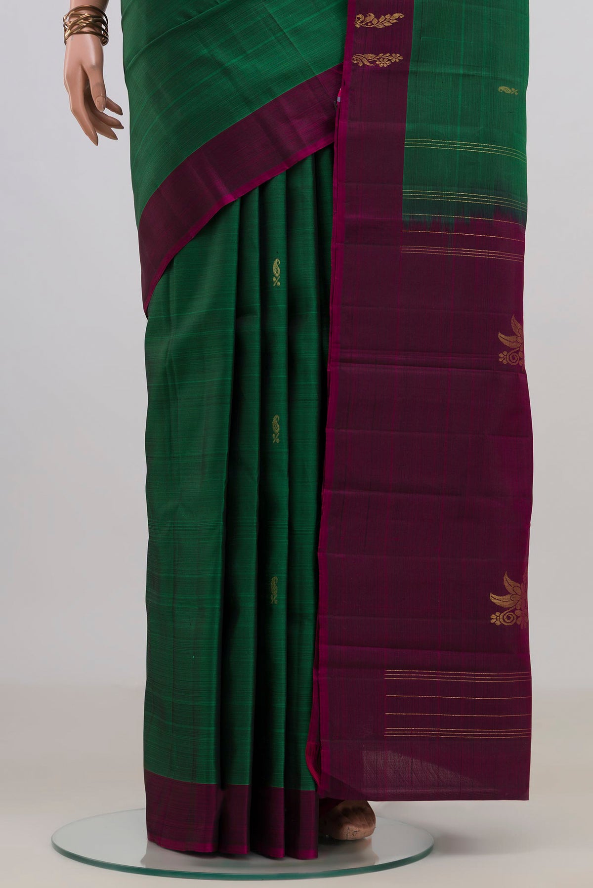 Pleats and pallu of Pure Silk Green Kanchipuram Saree with Zari Butta on the body and Fancy Border. 