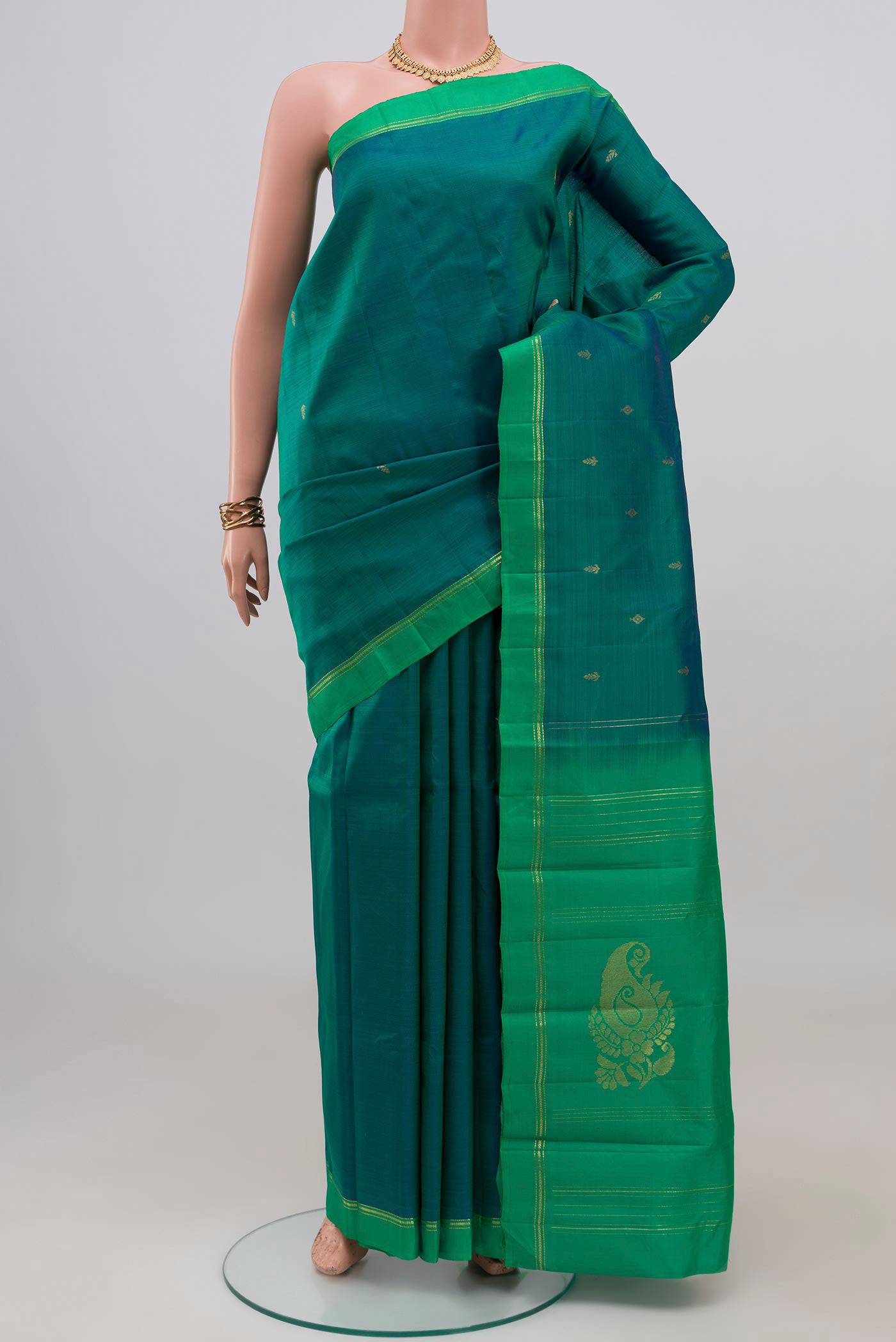 Peacock Blue Kanchipuram Silk Saree with Zari Butta on the body and Temple Border.  displayed on a mannequin