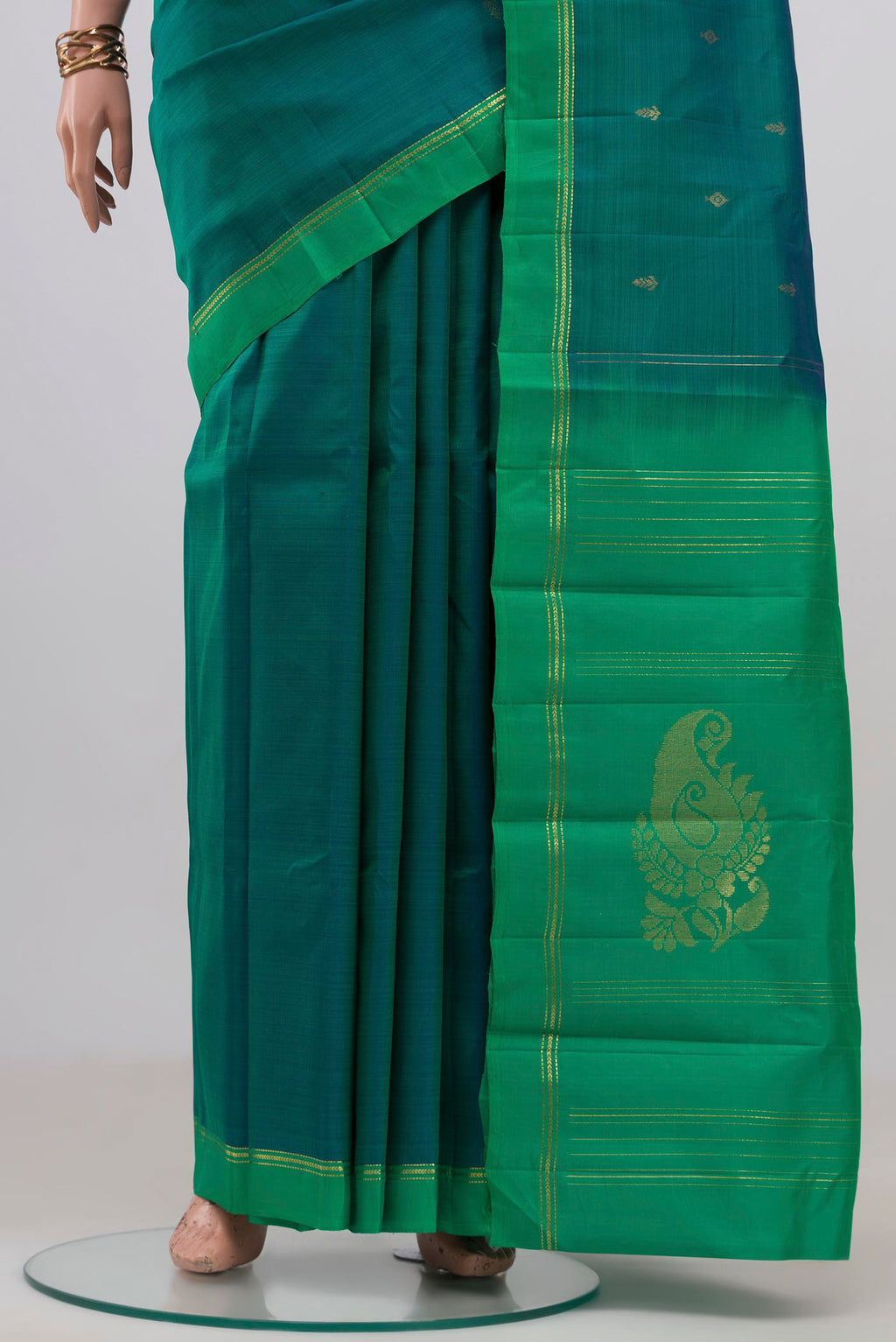 Pleats and pallu of Peacock Blue Kanchipuram Silk Saree with Zari Butta on the body and Temple Border. 