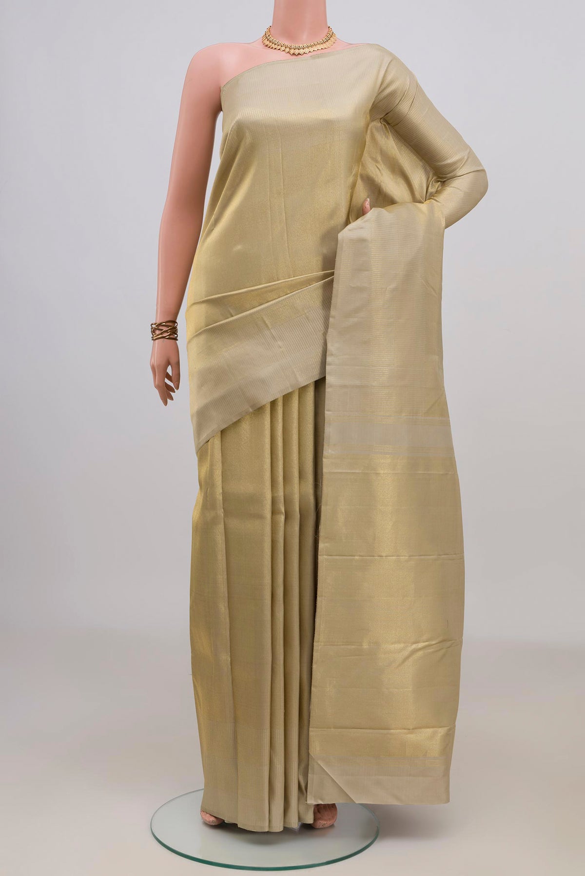 Pure Silk Gold Kanchipuram Saree with Zari Brocade on the body and Zari Border.  displayed on a mannequin