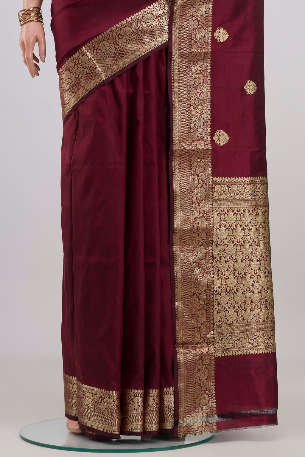 Pleats and pallu of Maroon Banarasi Katan Silk Saree with Zari Butta on the body and Zari Border. 