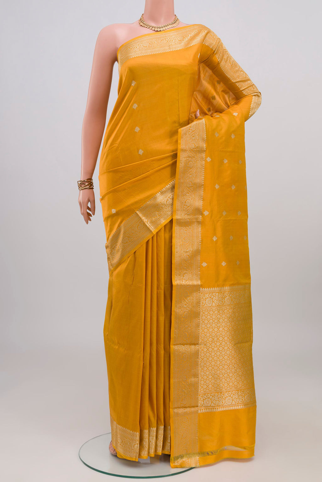 Yellow Banarasi Katan Silk Saree with Zari Butta on the body and Zari Border.  displayed on a mannequin