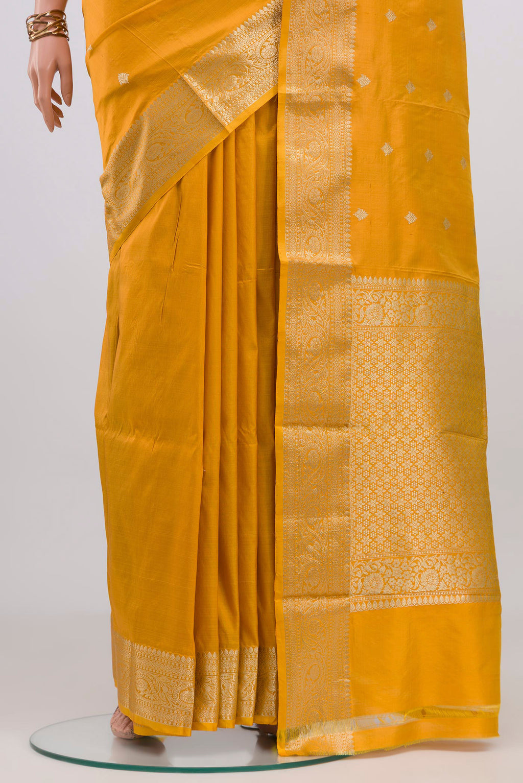 Pleats and pallu of Yellow Banarasi Katan Silk Saree with Zari Butta on the body and Zari Border. 