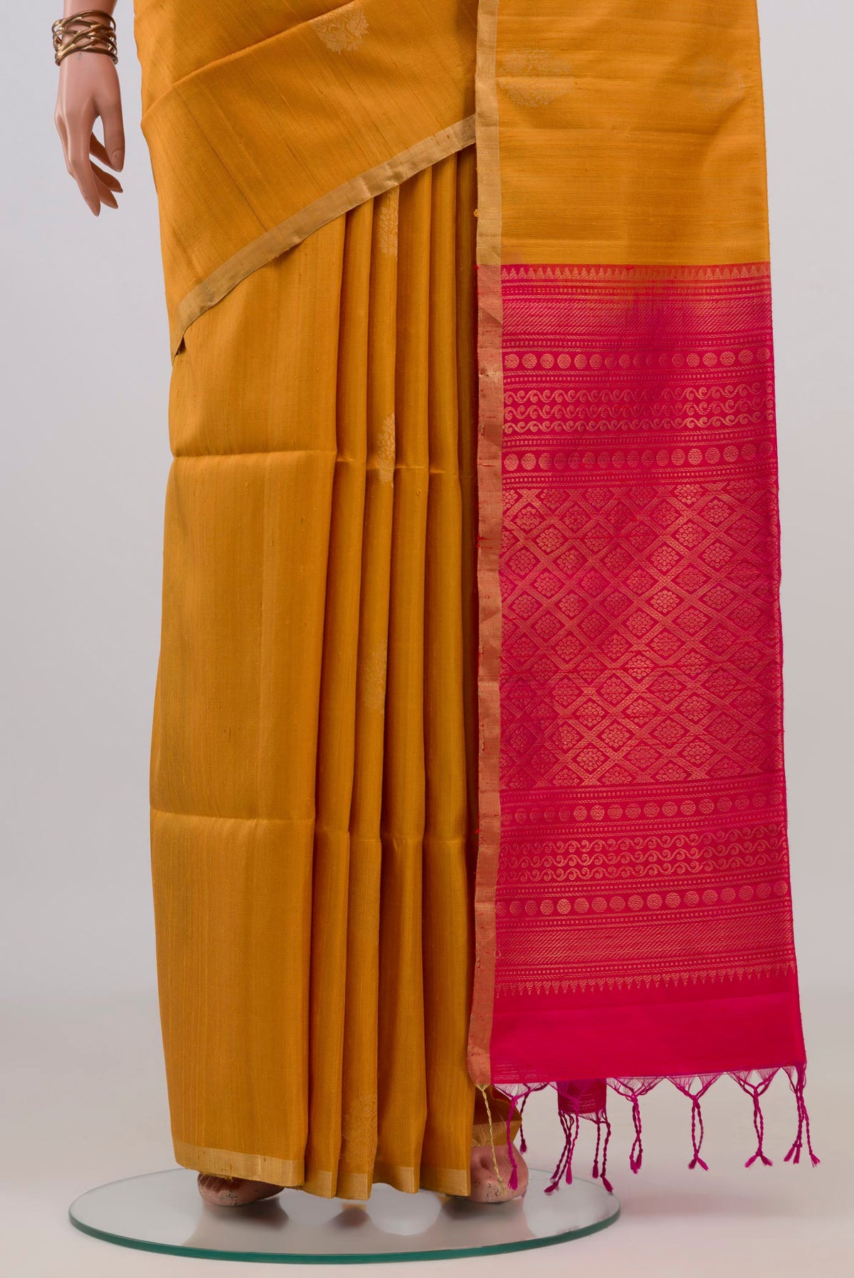 Pleats and pallu of Pure Silk Mustard Soft Saree with Zari Butta on the body and Zari Border. 