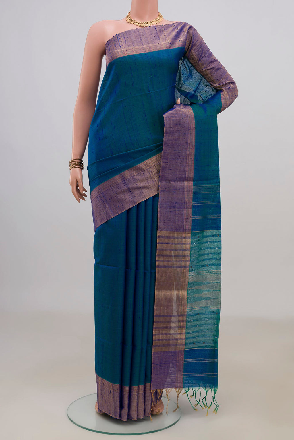 Pure Silk Peacock Blue Soft Saree with Plain Body and Zari Border.  displayed on a mannequin
