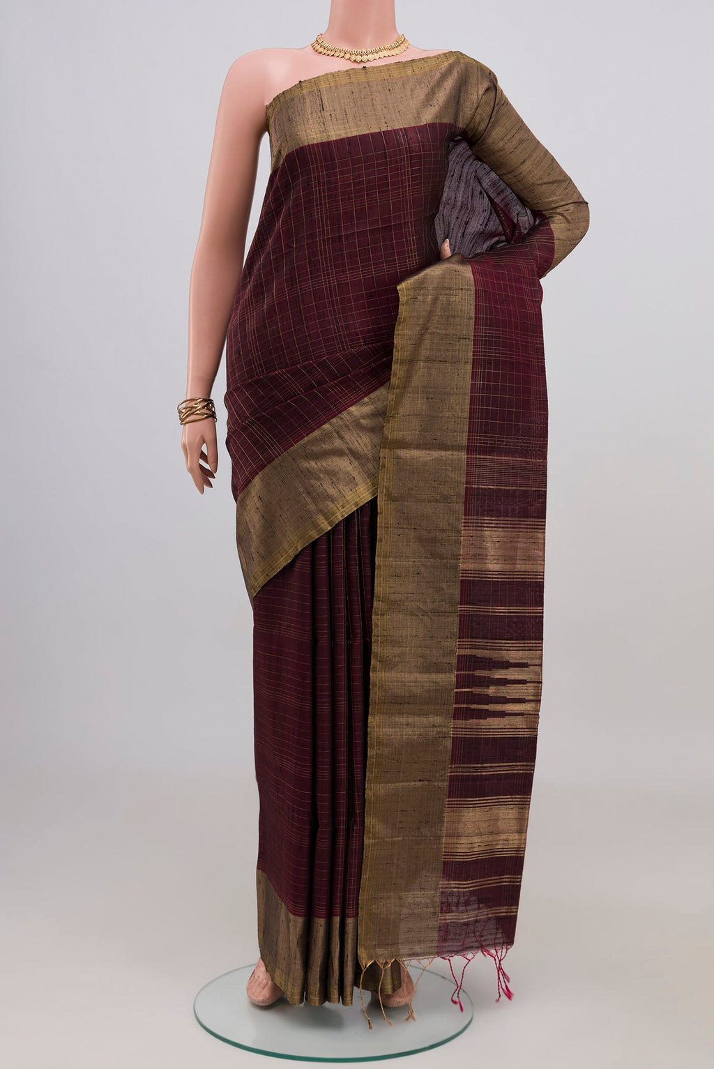 Brown Soft Silk Saree with Checked design on the body and Zari Border.  displayed on a mannequin