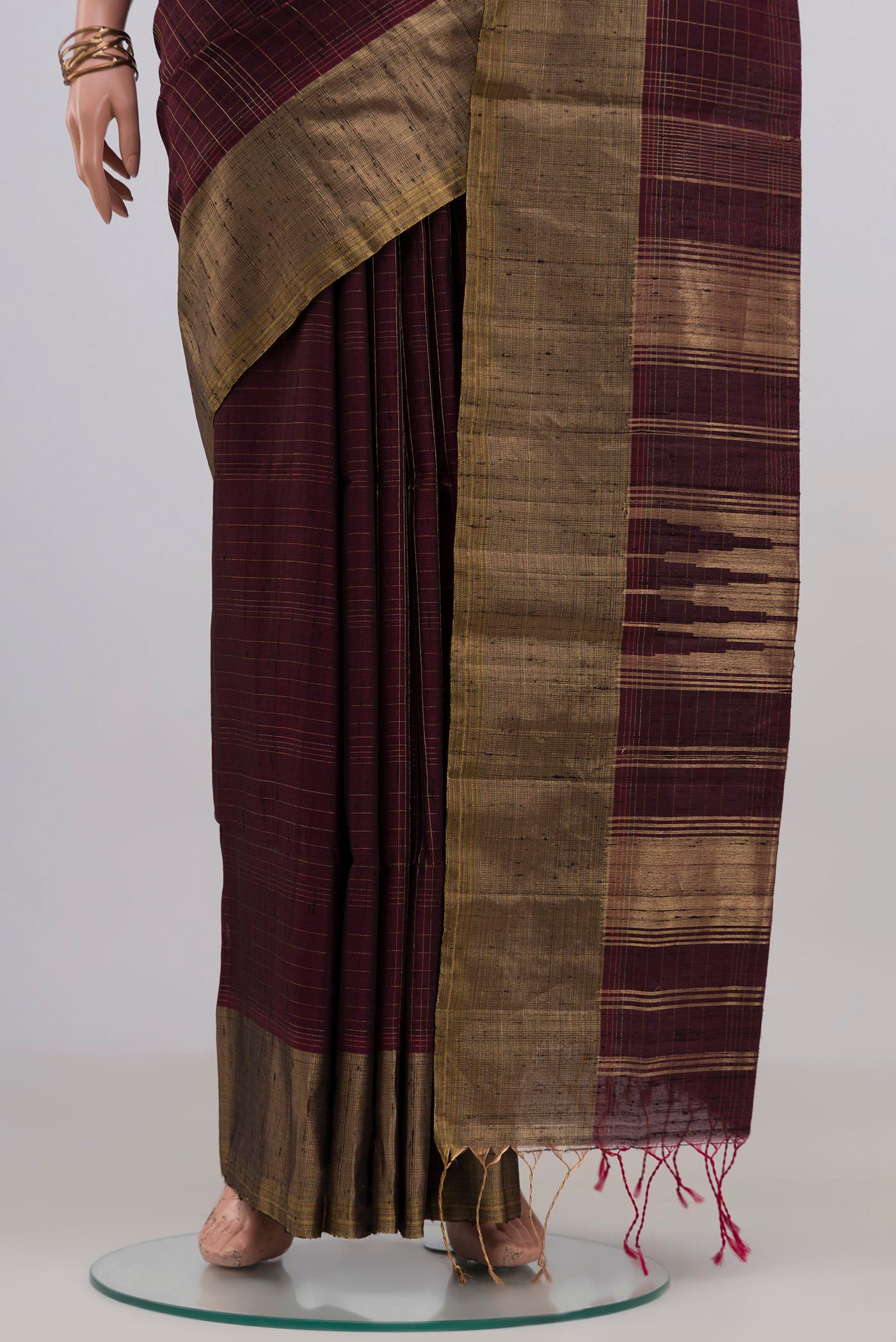 Pleats and pallu of Brown Soft Silk Saree with Checked design on the body and Zari Border. 