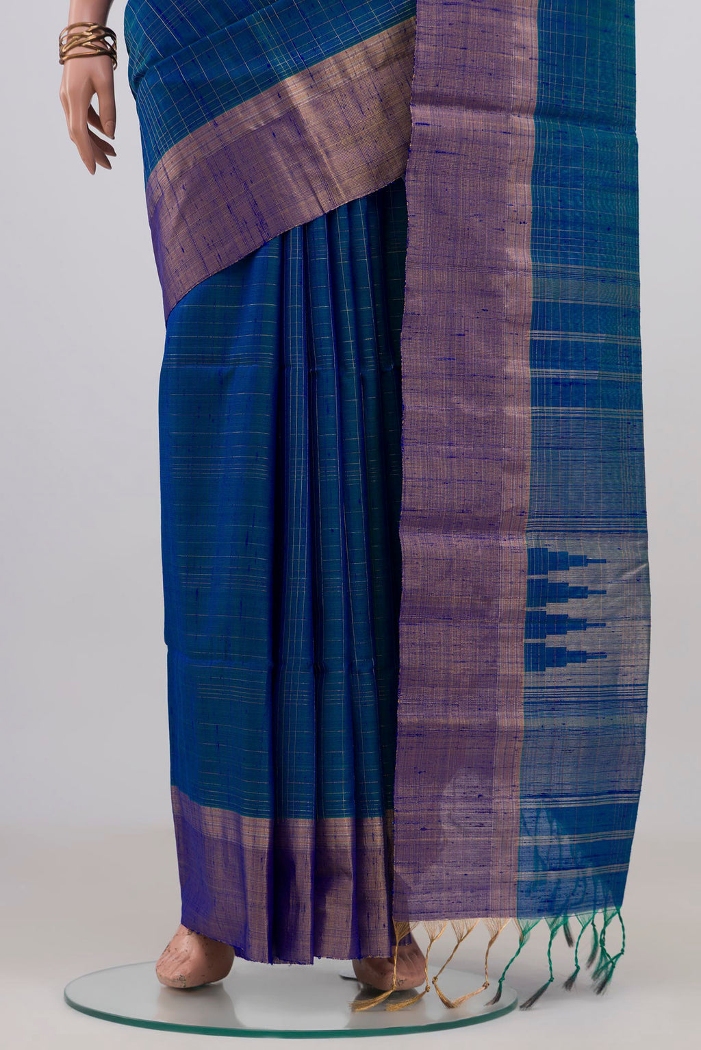 Pleats and pallu of Blue Raw Silk Saree with Checked design on the body and Zari Border. 
