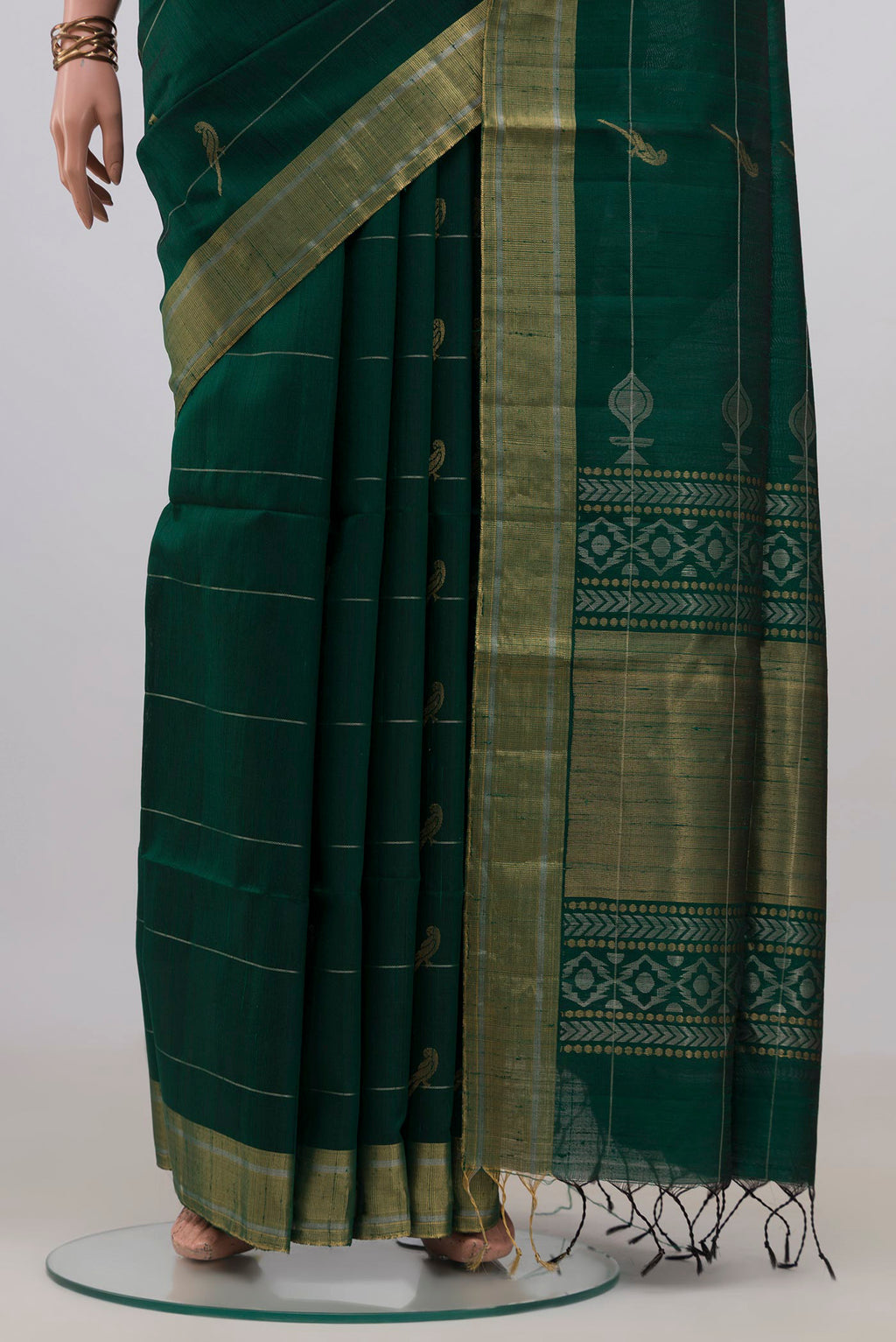 Pleats and pallu of Pure Silk Bottle Green Raw Saree with Stripes on the body and Zari Border. 