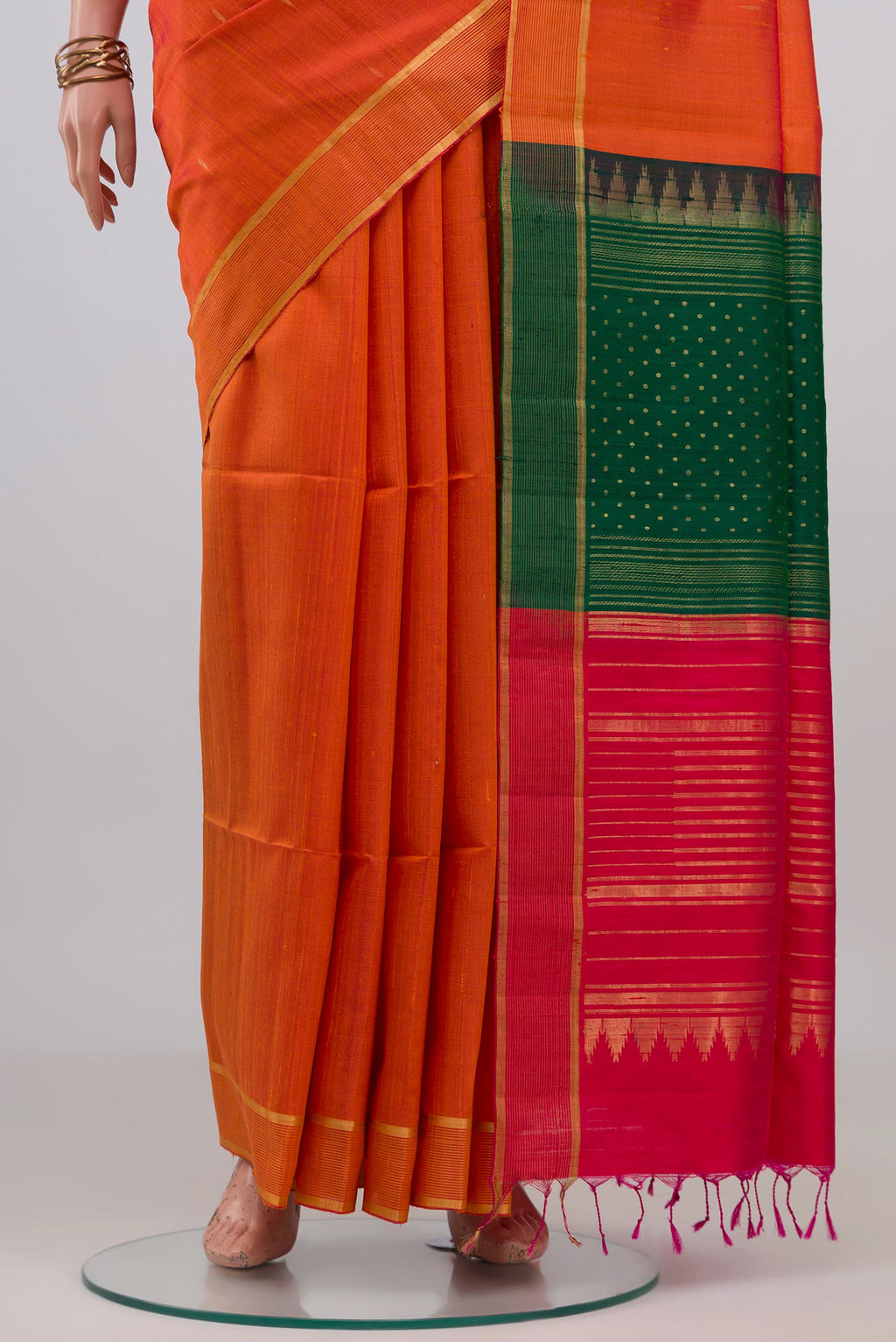 Pleats and pallu of Orange Banarasi Raw Silk Saree with Plain Body and Zari Border. 