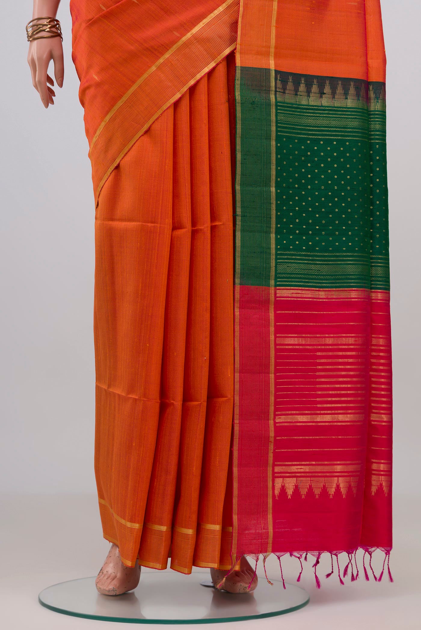Pleats and pallu of Orange Banarasi Raw Silk Saree with Plain Body and Zari Border. 