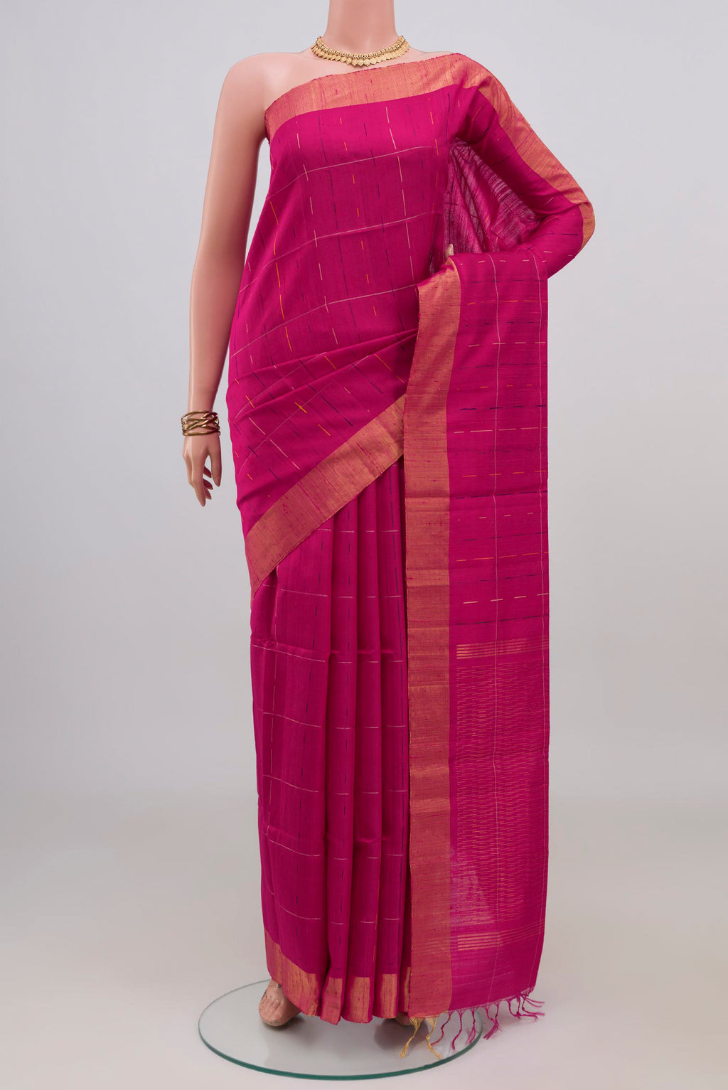 Rani Pink Raw Silk Saree with Checked design on the body and Zari Border.  displayed on a mannequin