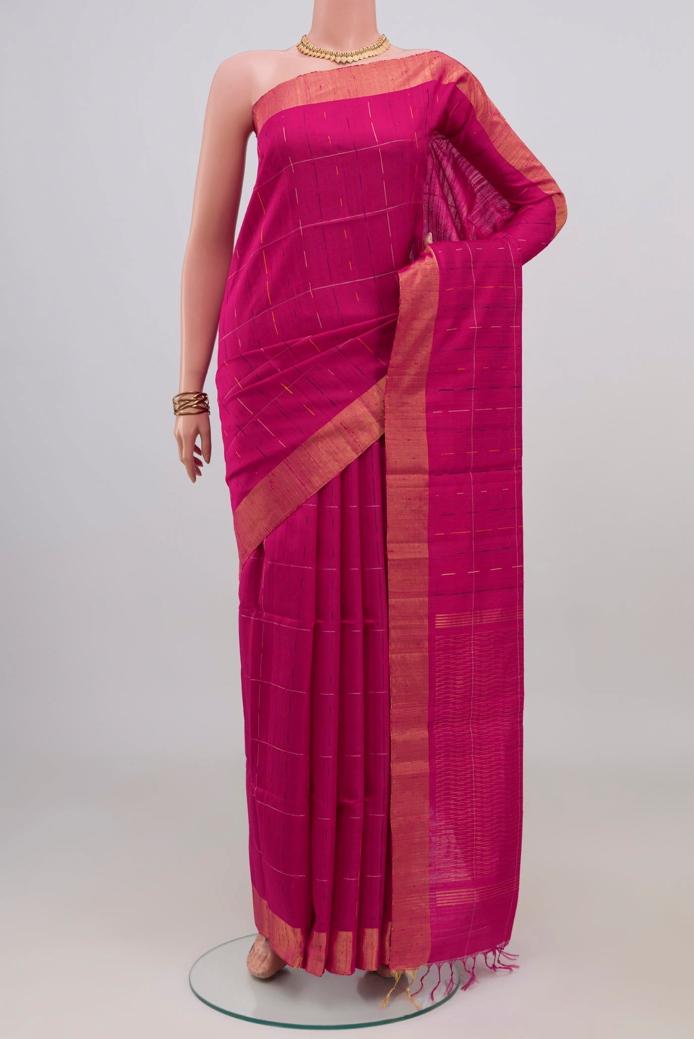 Rani Pink Raw Silk Saree with Checked design on the body and Zari Border.  displayed on a mannequin