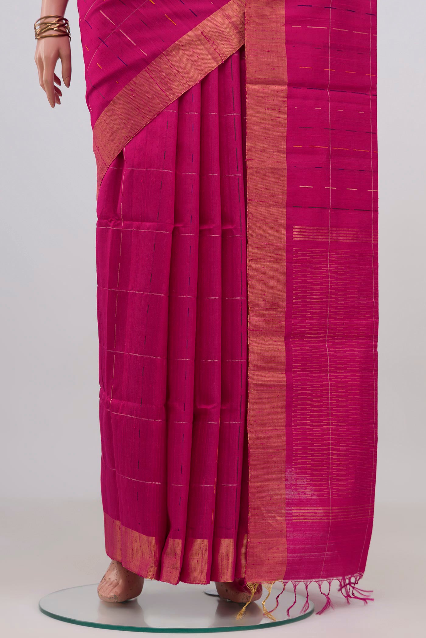 Pleats and pallu of Rani Pink Raw Silk Saree with Checked design on the body and Zari Border. 
