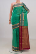 Pure Silk Green Kanchipuram Saree with Zari Butta on the body and Zari Border.  displayed on a mannequin