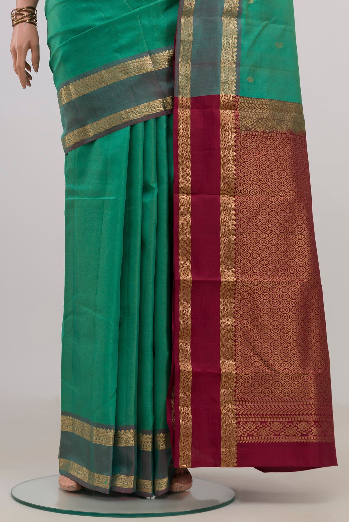 Pleats and pallu of Pure Silk Green Kanchipuram Saree with Zari Butta on the body and Zari Border. 