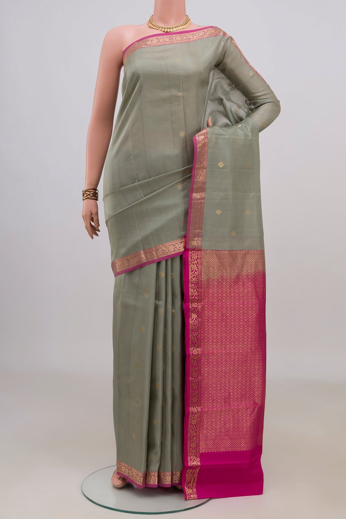 Pure Silk Grey Kanchipuram Saree with Zari Butta on the body and Zari Border.  displayed on a mannequin