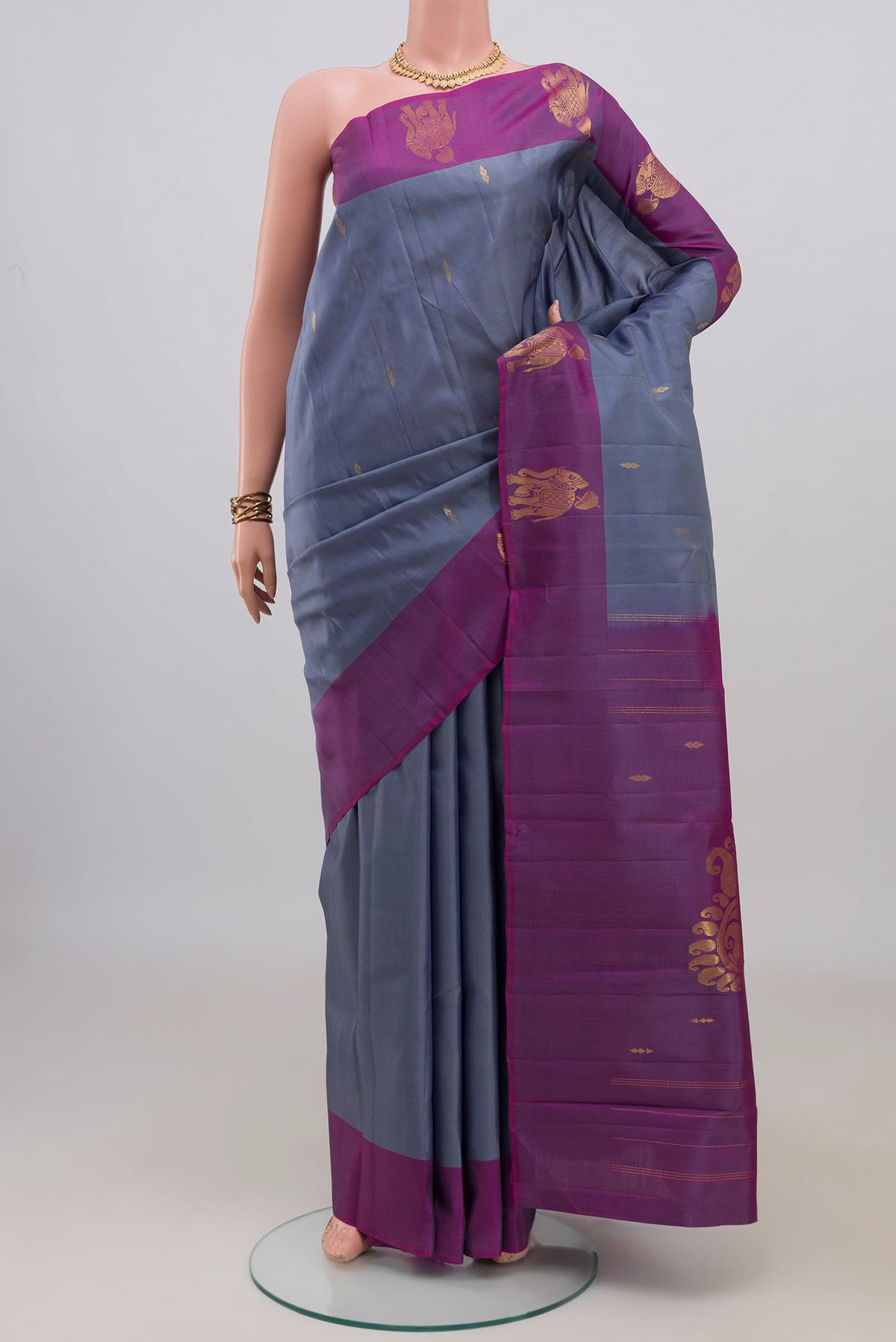 Pure Silk Grey Kanchipuram Saree with Zari Butta on the body and Fancy Border.  displayed on a mannequin