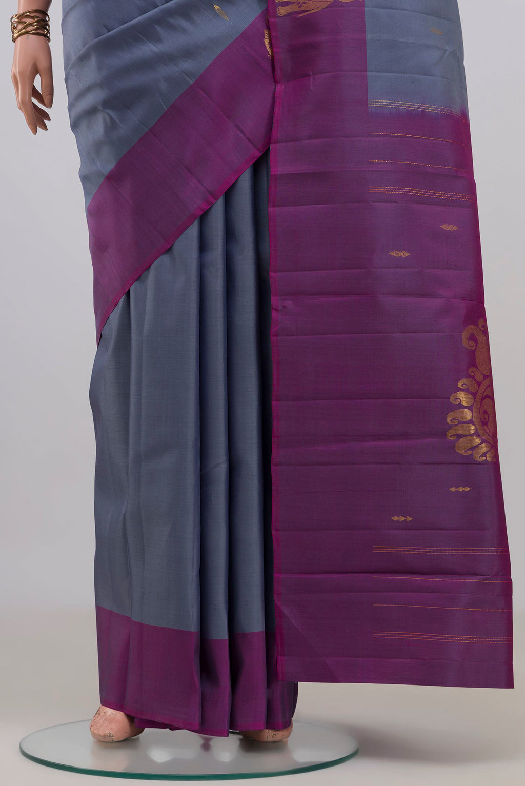 Pleats and pallu of Pure Silk Grey Kanchipuram Saree with Zari Butta on the body and Fancy Border. 