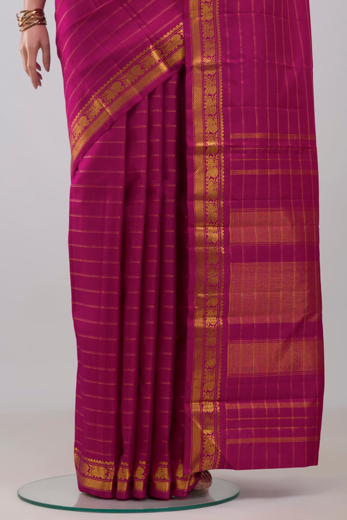 Pleats and pallu of Magenta Kanchipuram Silk Saree with Stripes on the body and Zari Border. 