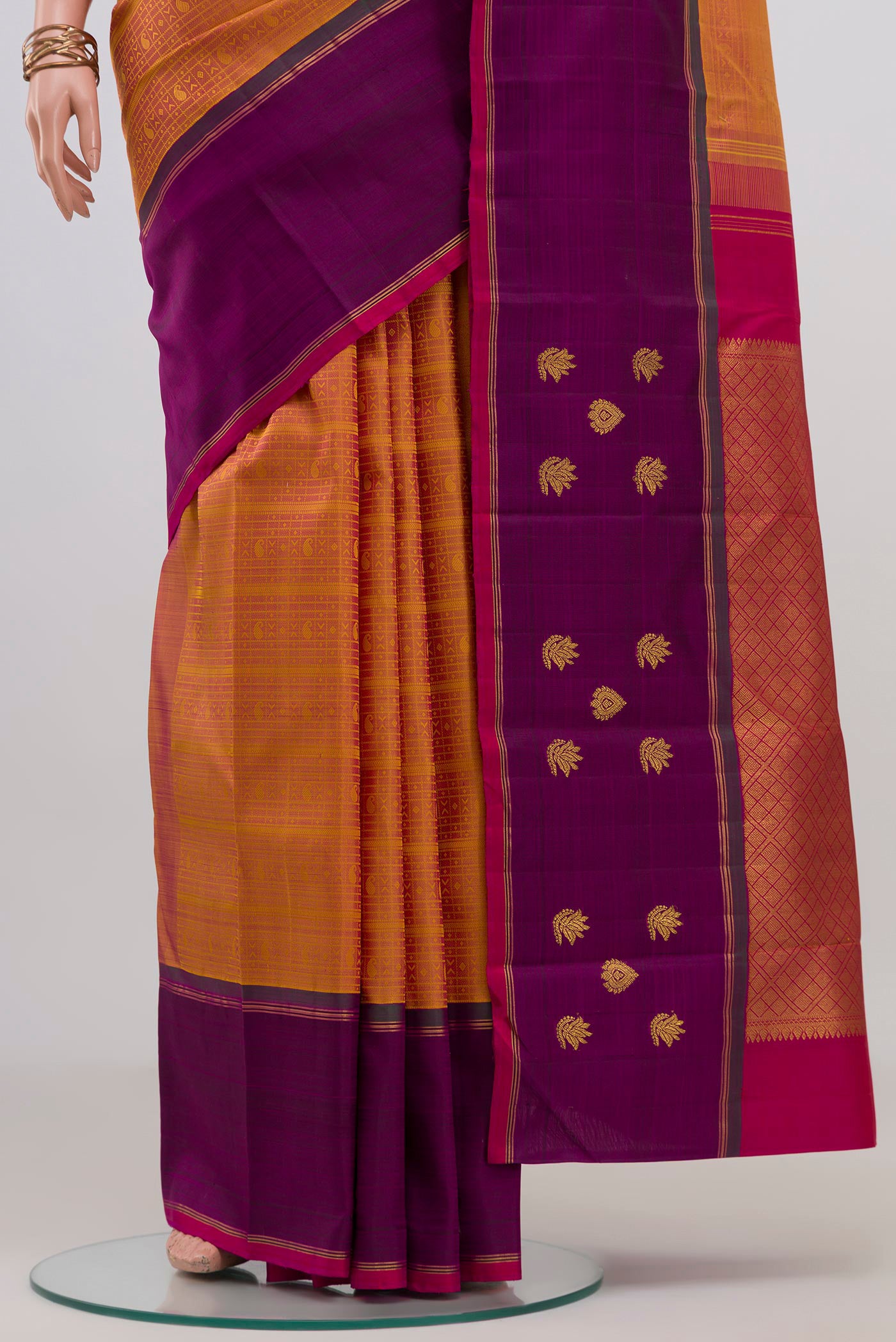 Pleats and pallu of Mustard Kanchipuram Silk Saree with Jacquard design on the body and Plain Border. 