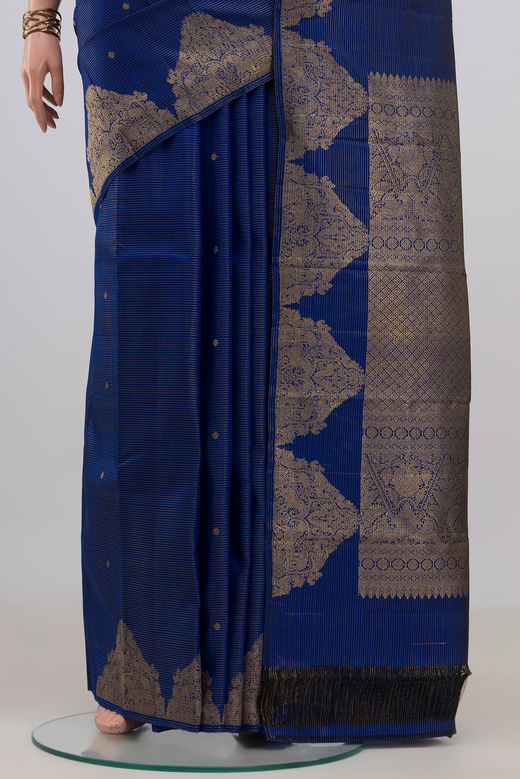 Pleats and pallu of Pure Silk Blue Kanchipuram Saree with Zari Butta on the body and Fancy Border. 