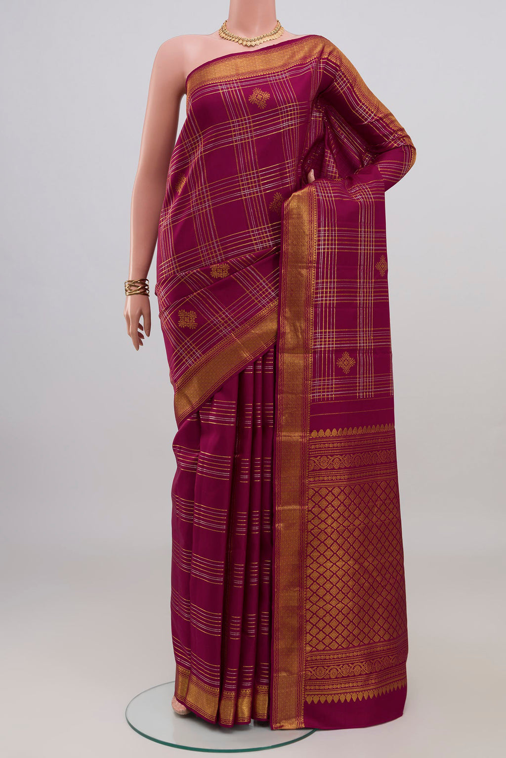 Maroon Kanjivaram Silk Saree with Checked design on the body and Zari Border.  displayed on a mannequin