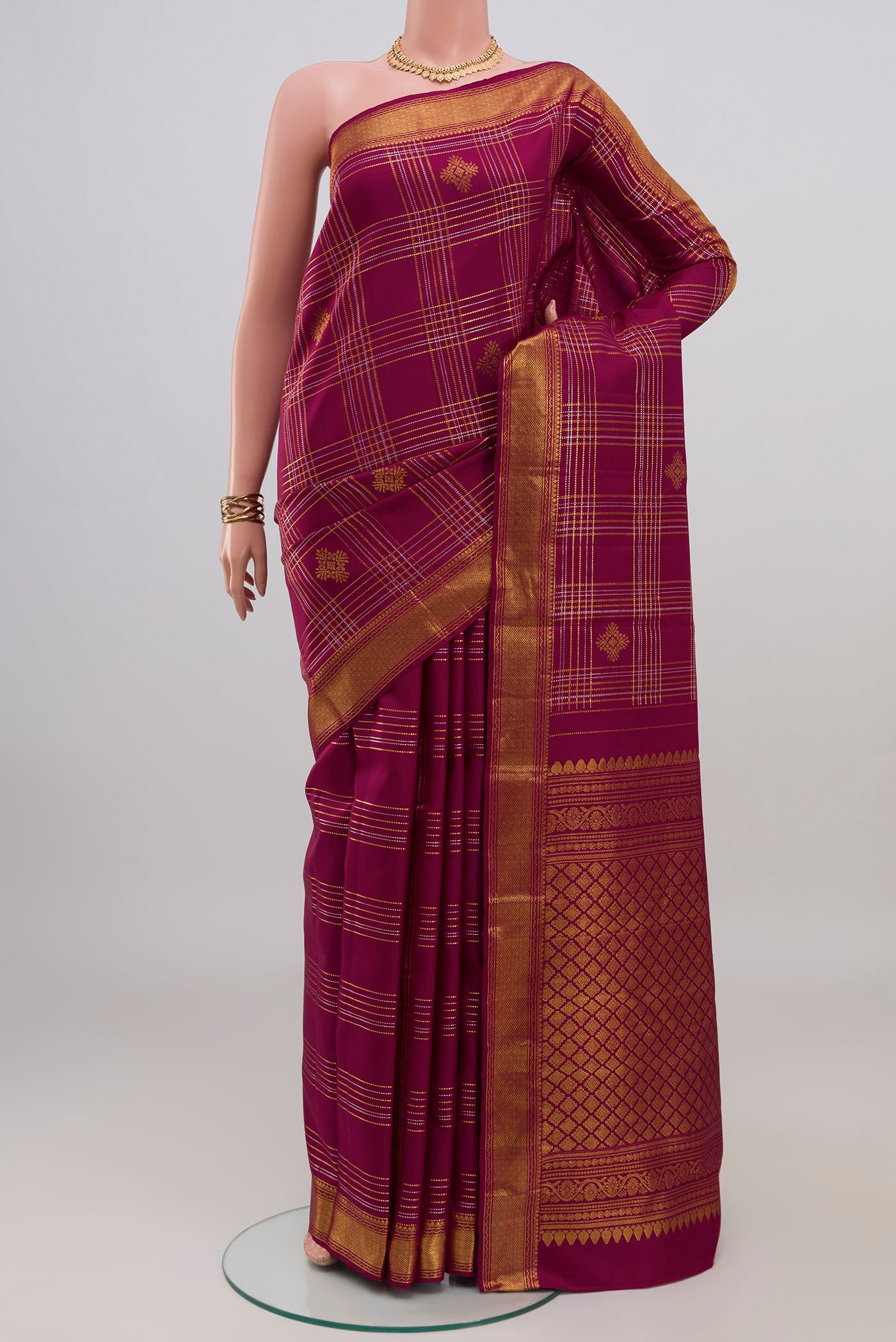 Maroon Kanjivaram Silk Saree with Checked design on the body and Zari Border.  displayed on a mannequin