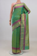 Pure Silk Green Kanjivaram Saree with Zari Butta on the body and Zari Border.  displayed on a mannequin