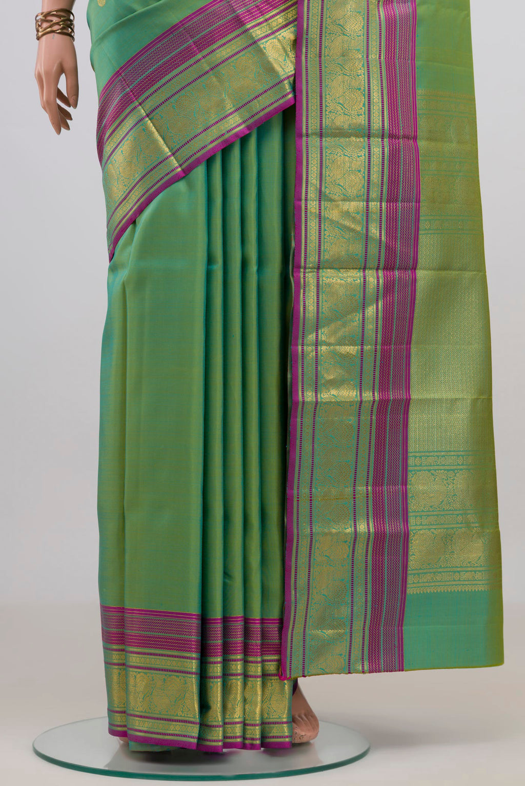 Pleats and pallu of Pure Silk Green Kanjivaram Saree with Zari Butta on the body and Zari Border. 