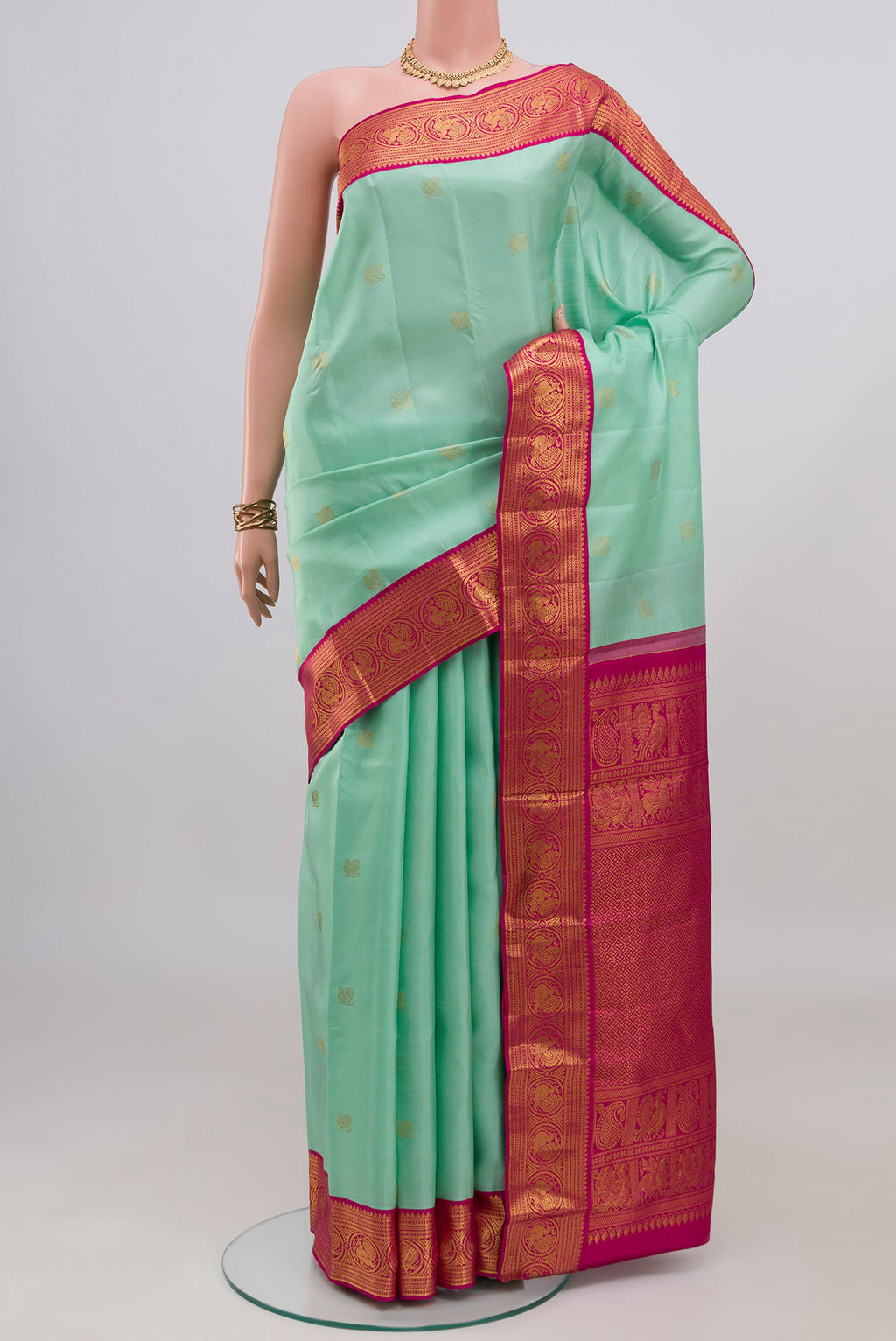 Sky Blue Kanjivaram Silk Saree with Zari Butta on the body and Zari Border.  displayed on a mannequin