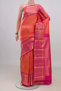 Pure Silk Coral Kanjivaram Saree with Zari Brocade on the body and Zari Border.  displayed on a mannequin