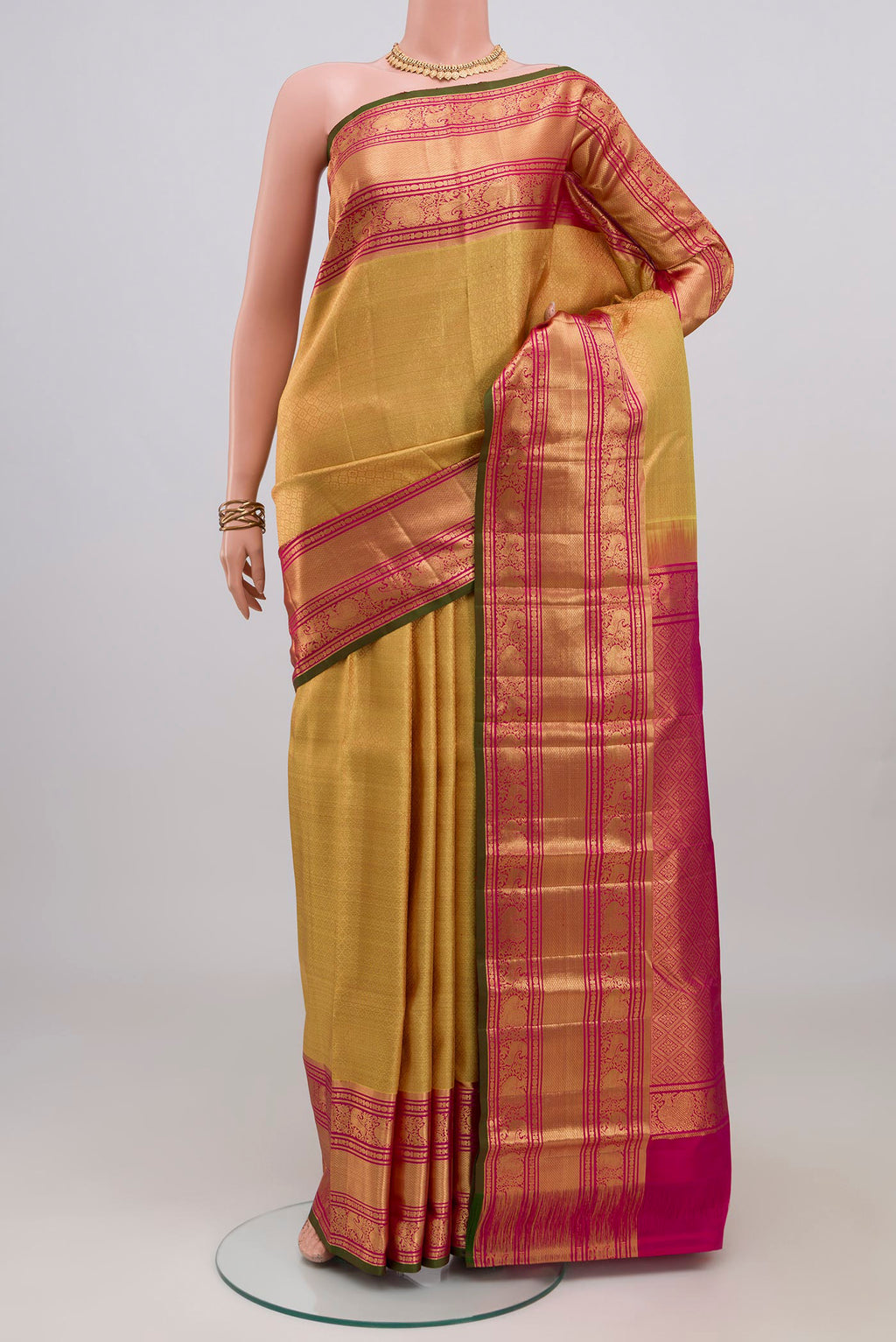 Golden Kanjivaram Silk Saree with Zari Brocade on the body and Zari Border.  displayed on a mannequin