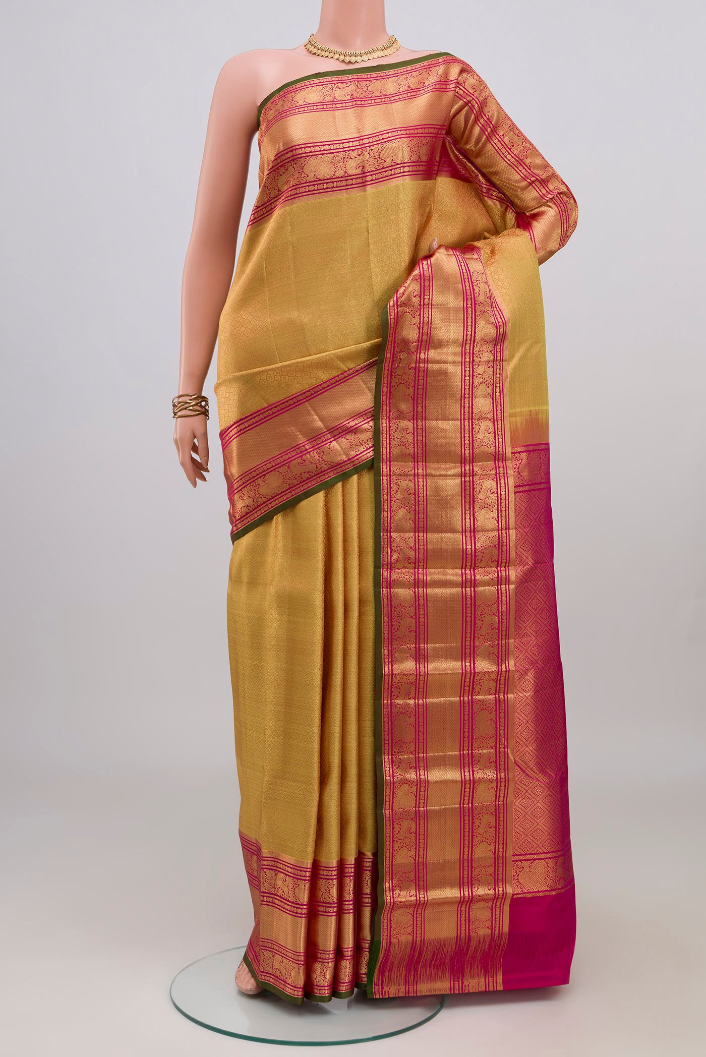 Golden Kanjivaram Silk Saree with Zari Brocade on the body and Zari Border.  displayed on a mannequin