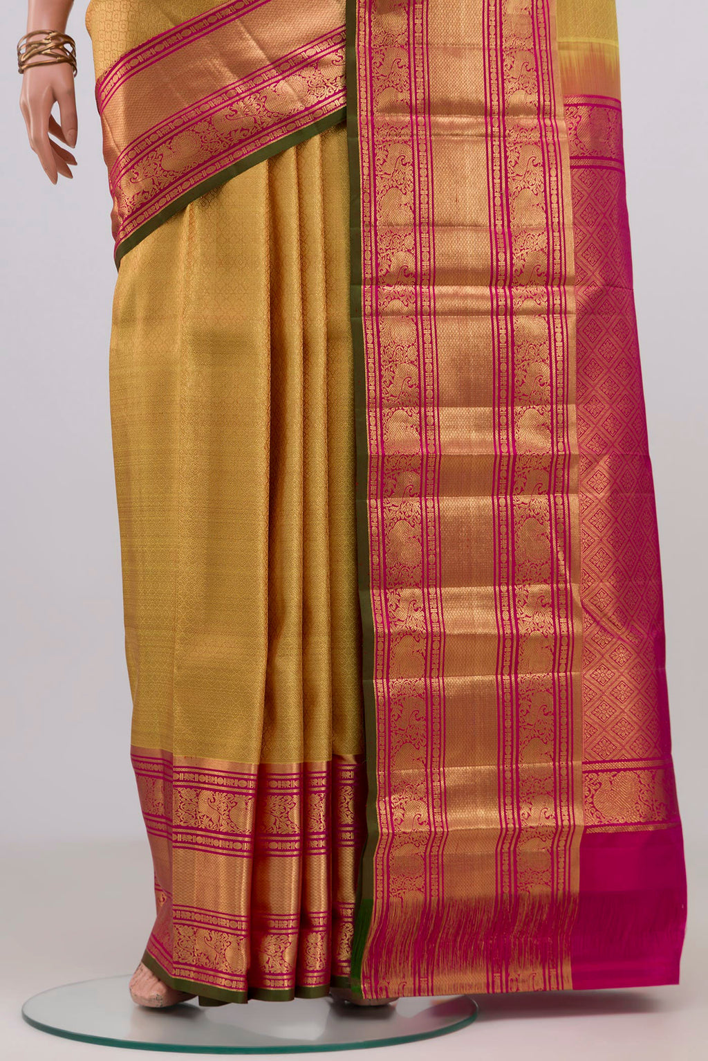 Pleats and pallu of Golden Kanjivaram Silk Saree with Zari Brocade on the body and Zari Border. 