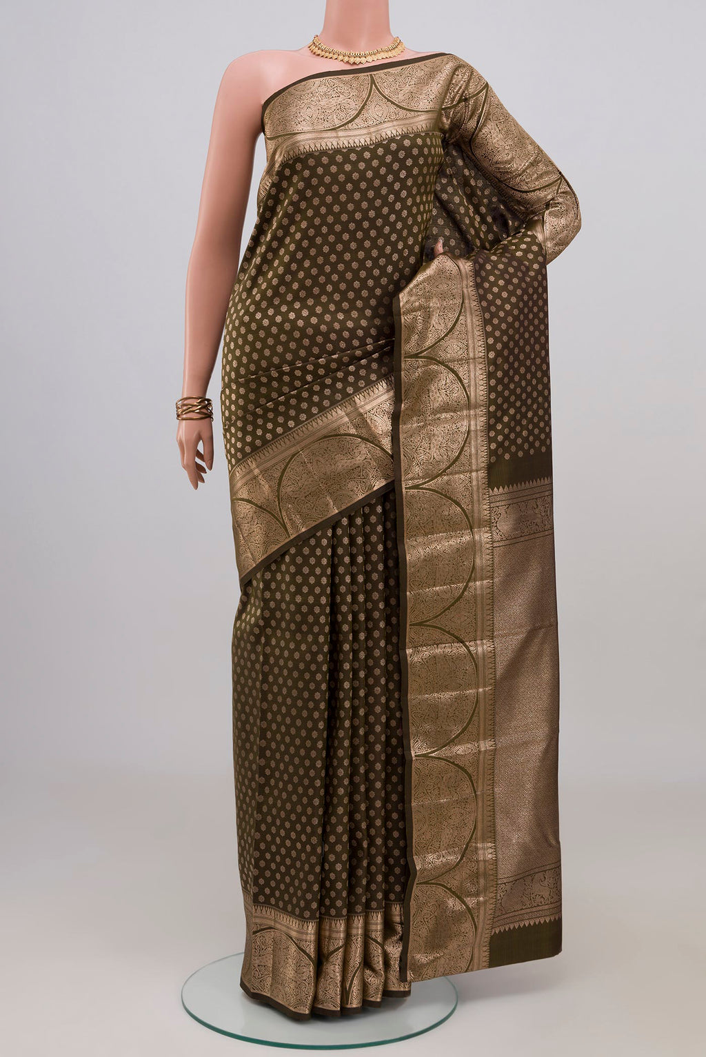 Mehandi Green Kanjivaram Silk Saree with Zari Butta on the body and Zari Border.  displayed on a mannequin