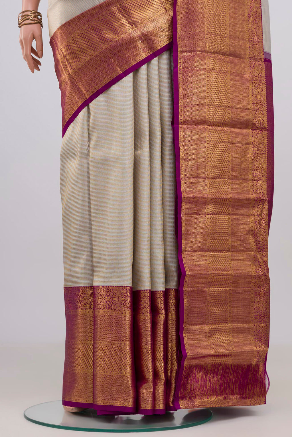 Pleats and pallu of Off White Kanchipuram Silk Saree with Zari Brocade on the body and Zari Border. 