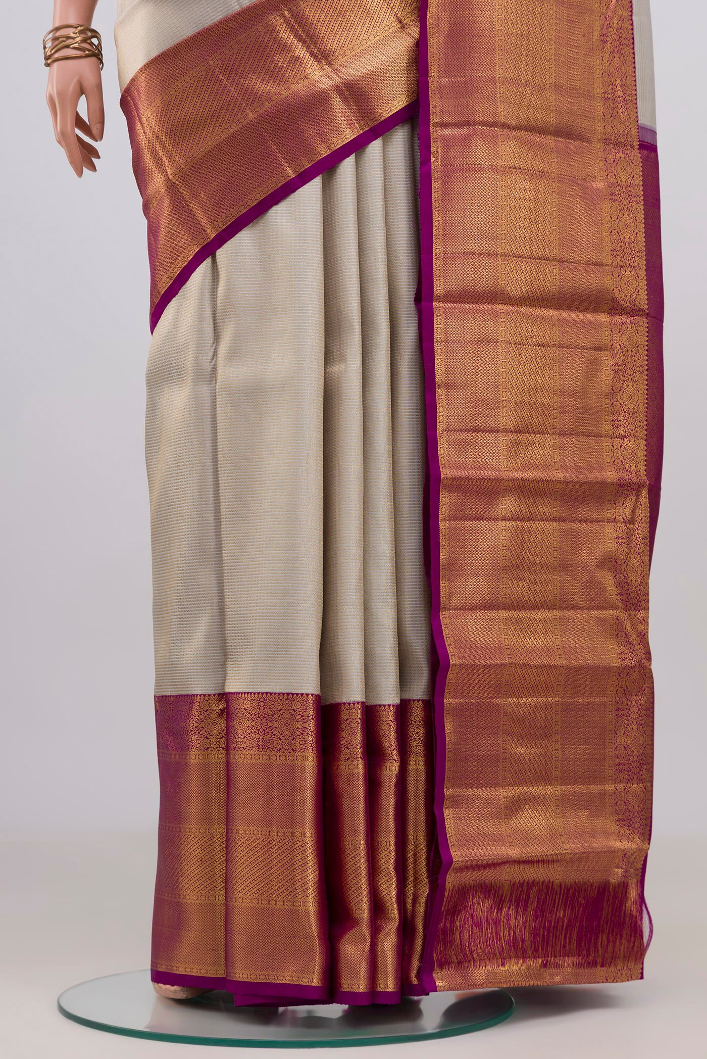 Pleats and pallu of Off White Kanchipuram Silk Saree with Zari Brocade on the body and Zari Border. 