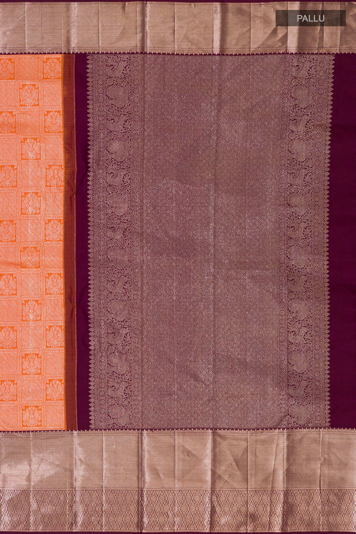 Close up image of the pallu of Orange Kanchipuram Silk Saree with Zari Brocade on the body and Zari Border. 