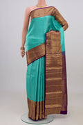 Light Blue Kanchipuram Silk Saree with Zari Brocade on the body and Zari Border.  displayed on a mannequin