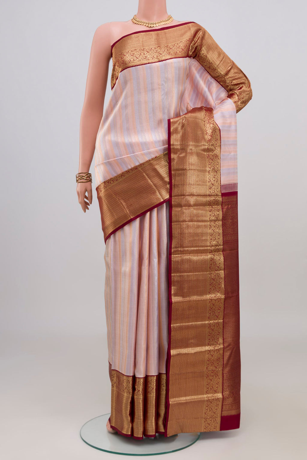 Rose Gold Kanchipuram Silk Saree with Zari Brocade on the body and Zari Border.  displayed on a mannequin